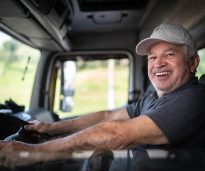 Smiling Man Driving A Truck